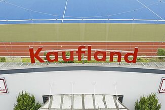 Kaufland-logo in front of a REGUPOL running track